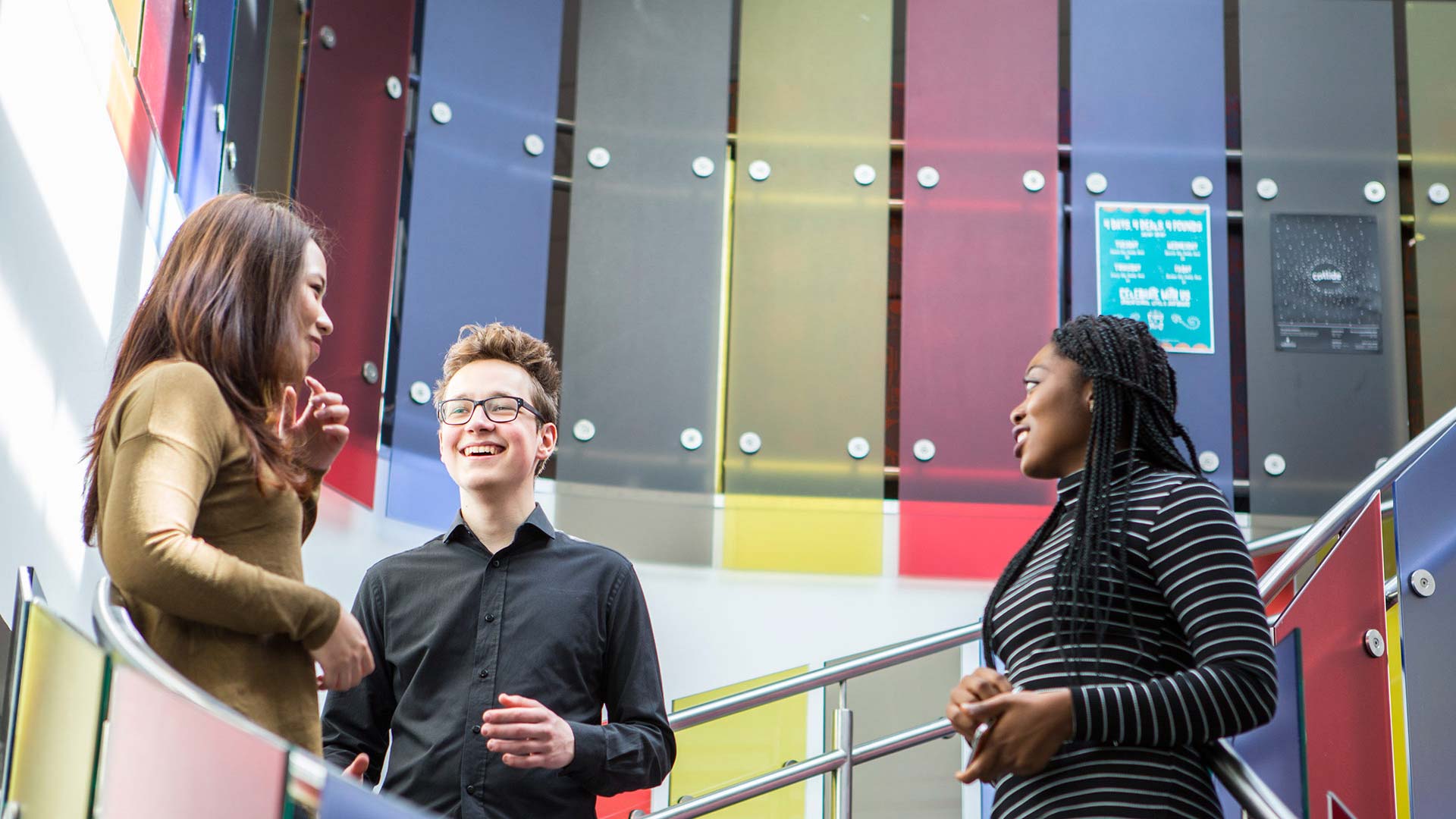 A group of students chatting on staircase.