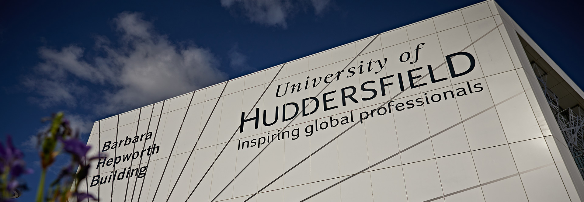 The University of Huddersfield's Barbara Hepworth building displaying the name of the university with the tagline 