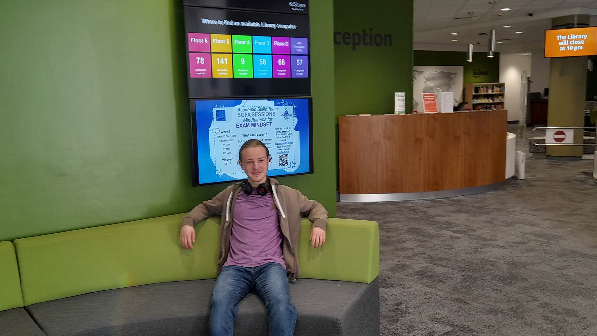 Nathan sat on a sofa by the entrance to the University library.