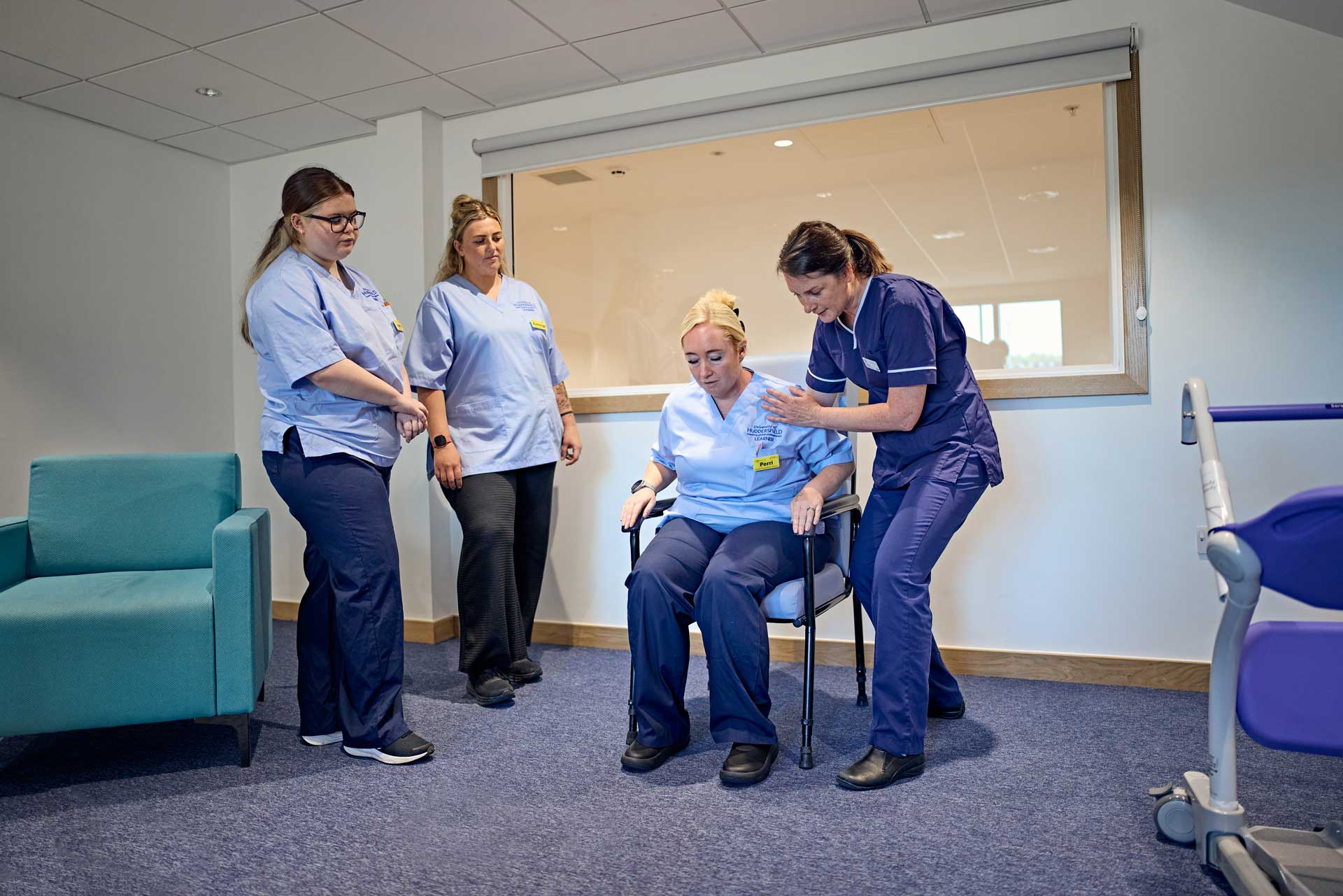 occupational therapist guides a student through safe sit-to-stand techniques.